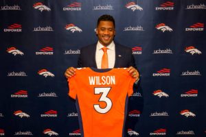 ENGLEWOOD, CO - MARCH 16:  Quarterback Russell Wilson #3 of the Denver Broncos poses with his jersey after speaking to the media at UCHealth Training Center on March 16, 2022 in Englewood, Colorado. (Photo by Justin Edmonds/Getty Images)
